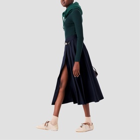 Model wearing Maje Womens French Dress in multi, styled with a dark green hooded top and cream embellished flat shoes