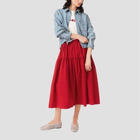 Model wearing Maje Womens French Dress in red, tiered midi skirt style, styled with denim jacket and checkered flats