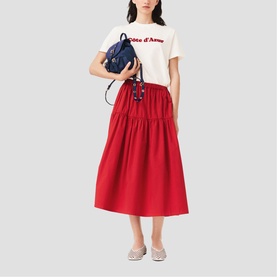 Model wearing Maje Womens French Dress in red, styled with a white graphic tee, navy mini backpack and silver flat shoes.