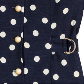 Maje navy dots print dress close-up showing pearl buttons and gold buckle belt detail on polka dot fabric