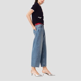 Model wearing Maje wide-leg blue jeans with red waistband detail, styled with a navy top and silver kitten heel mules.