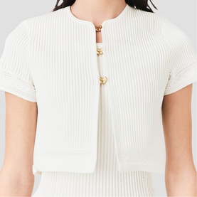 Model wearing Maje metallic white ribbed short-sleeve cardigan with gold button fastenings, cropped fit