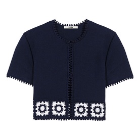 Maje navy blue cropped cardigan with white crochet floral hem panel, pom-pom trim, short sleeves, and button front