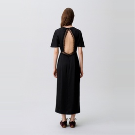 Model wearing Claude Pierlot Lace Slit Dress in black, showing open back with lace trim detail, midi length, short sleeves, paired with dark heels
