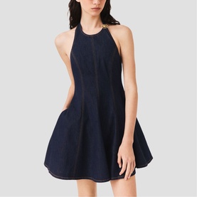 Model wearing Maje Womens French Dress in dark indigo denim, halterneck mini fit-and-flare silhouette with gold neck detail