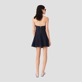Model wearing Maje Womens French Dress in navy, strapless fit-and-flare silhouette, mini length, styled with silver heels