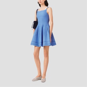 Model wearing Maje Womens French Dress in blue, fit-and-flare silhouette with square neck and thin straps, styled with striped flats and black bag