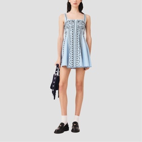 Model wearing Maje Womens French Dress in light blue with broderie anglaise detail, styled with black loafers and carrying a navy bag.