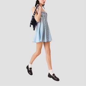 Model wearing Maje Womens French Dress in multi, blue broderie mini dress with dark floral embroidery, styled with black loafers and carried scarf