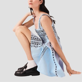 Model wearing Maje Womens French Dress in light blue with dark embellished detail, styled with black loafers and white socks