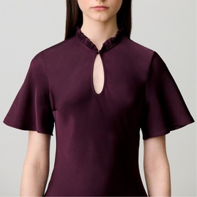 Model wearing Claude Pierlot Womens French Dress in Dark Dahlia, featuring flutter sleeves, frill mandarin collar and keyhole neckline detail.