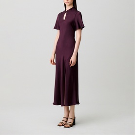 Model wearing Claude Pierlot Womens French Dress in Dark Dahlia, midi length with flutter sleeves and keyhole neckline, styled with strappy sandals.