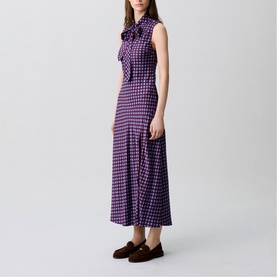 Model wearing Claude Pierlot Womens French Dress in burgundy print, sleeveless midi length with bow neckline, styled with brown loafers