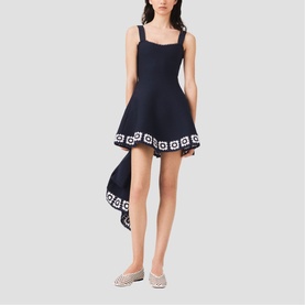 Model wearing Maje Womens French Dress in navy with white geometric border trim, asymmetric hem, square neckline and straps, styled with silver flats