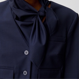 Model wearing Claude Pierlot Cropped Single-Breasted Blazer in blue, styled with removable bow scarf collar, double-button front detail visible.