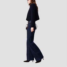 Model wearing Maje wide-leg dark navy trousers and black knit top, styled with a waist belt and black heels