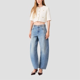 Model wearing cream cropped short-sleeve cardigan with gold buttons, styled with wide-leg light wash jeans and dark pointed heels.