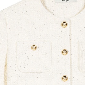 Maje cream boucle jacket close-up showing gold lion-head buttons and patch pocket detail with metallic fleck tweed fabric