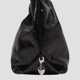 Maje black patent leather hobo bag with silver heart charm hardware and structured silhouette