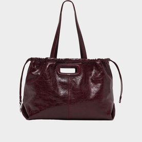 Maje burgundy patent leather tote bag with gold M-bar hardware, dual top handles and drawstring side details