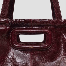 Maje burgundy crinkled patent leather tote bag with structured rectangular top handle and gold-tone logo detail