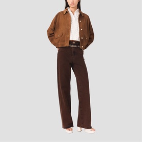 Model wearing Maje wide-leg dark brown trousers with a tan cropped jacket, white shirt, and black belt.