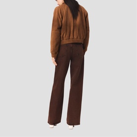 Model wearing Maje brown cropped suede-effect bomber jacket and wide-leg dark brown trousers, shown from the back