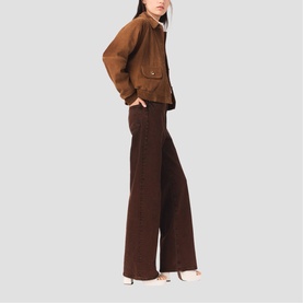 Model wearing Maje wide-leg brown trousers and cropped brown suede jacket, styled with nude heeled mules.