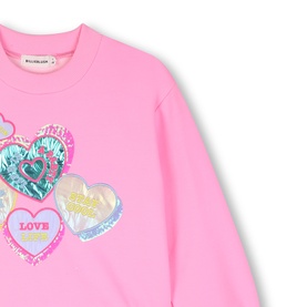 Billy Blush pink dress with multicoloured heart patch graphics and Love slogan, close-up of chest detail