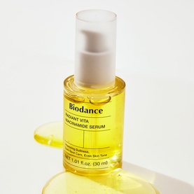 Biodance Radiant Vita Niacinamide Serum in clear yellow glass pump bottle, 30ml, shown upright on white background