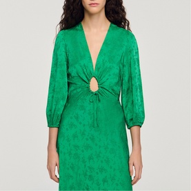 Model wearing Sandro Womens French Dress in green jacquard fabric with deep V-neck, ring cutout detail, and puff sleeves
