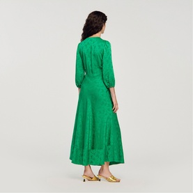 Model wearing Sandro Womens French Dress in green jacquard midi length, styled with gold mule heels, rear view