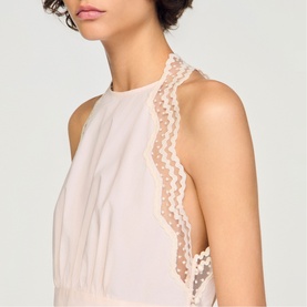 Model wearing Sandro light pink sleeveless top with delicate lace and polka dot trim detail at front