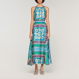 Model wearing Sandro Womens French Dress in green and purple floral scarf print, sleeveless halterneck style, midi length