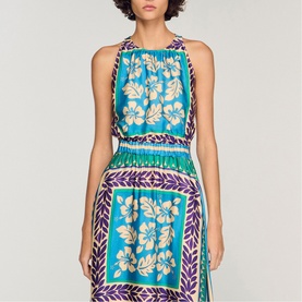 Model wearing Sandro Womens French Dress in green and purple floral scarf print with ruched bodice and pleated skirt