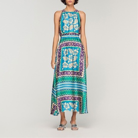 Model wearing Sandro Womens French Dress in green and purple scarf-print maxi style with halterneck and elasticated waist, styled with silver sandals.