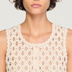 Model wearing Sandro cream broderie anglaise sleeveless top with scalloped neckline and pearl button detail