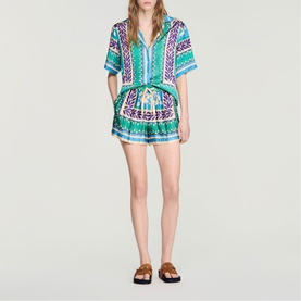 Model wearing Sandro Womens French Dress in green and purple geometric print, styled with brown flat sandals