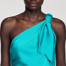 Model wearing Sandro green satin one-shoulder dress with knotted detail at shoulder