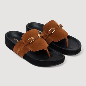 Sandro brown suede toe-post flatform slides with double gold-buckle strap detail and black moulded sole.