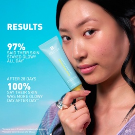 Model with Erborian Glow Moisturiser tube, results claim overlay showing 97% glowy skin all day and 100% after 28 days