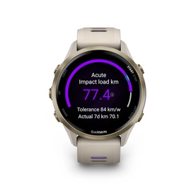 Garmin Forerunner 970 Smartwatch in beige with gold-tone case, displaying Acute Impact Load fitness metric on screen