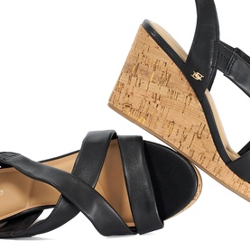 Dune black leather crossover strap wedge sandals with natural cork wedge heel and tan footbed, close-up detail shot