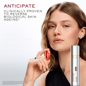 Model with Lanc&ocirc;me Absolue Longevity Anticipate Cream held near face, white and gold tube packaging visible