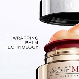 Lanc&ocirc;me Absolue Longevity Reset Cream jar with lid lifted, highlighting Wrapping Balm Technology and gold packaging detail