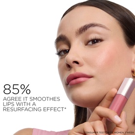 Model with Lanc&ocirc;me lipstick in shade 21 Blushing Blanket held near face, with 85% smoothing and resurfacing effect claim text overlay.