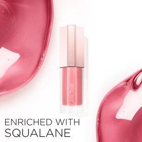 Lanc&ocirc;me lip gloss in 21 Blushing Blanket, pink tinted bottle with squalane-enriched formula shown against pink gloss swatches