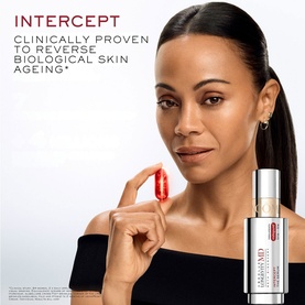 Model with Lanc&ocirc;me Absolue Longevity Intercept Serum, holding a single red capsule alongside the product bottle
