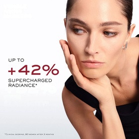 Model with Lanc&ocirc;me Absolue Longevity Intercept Serum, showcasing radiant, luminous skin with a +42% supercharged radiance claim.