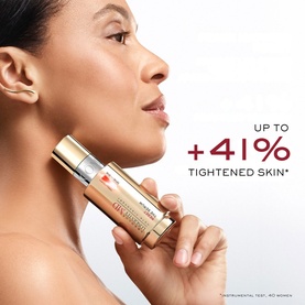 Model with Lanc&ocirc;me Absolue Longevity Reset Serum held near face, gold and red cylindrical bottle, alongside skin tightening claim text